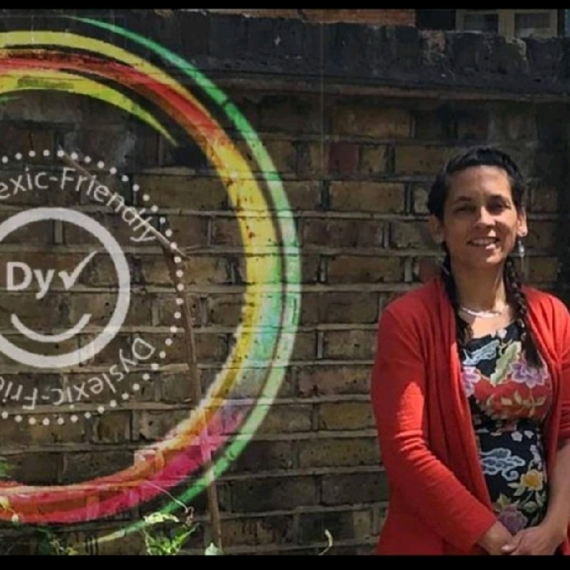 Eury Caldwell beside the GENER8TE ‘Dyslexic-Friendly’ rainbow-ring brand mark